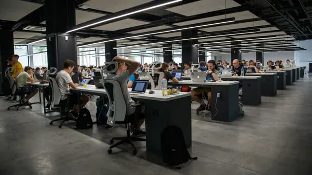 Enterprise team reviewing a wall of connected workflow diagrams and software tools