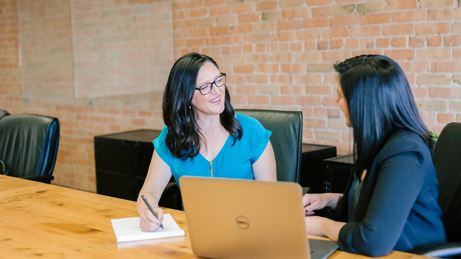 Candidate interview and hiring dashboard reviewed on a laptop in a conference room