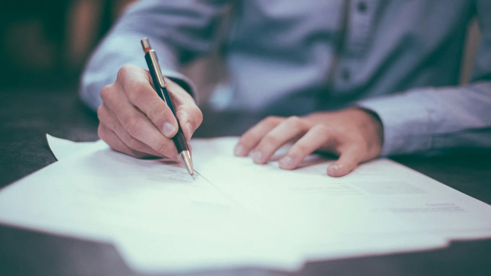 Compliance documents and financial charts reviewed on a conference table