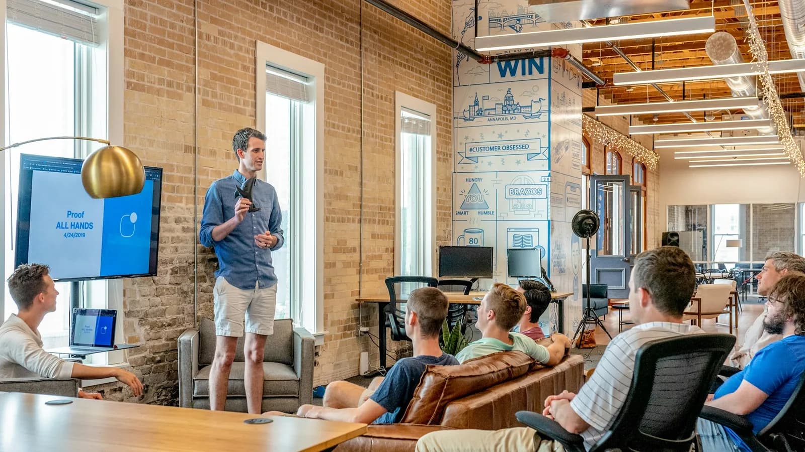 Calibration team reviews workflow metrics together in a glass conference room