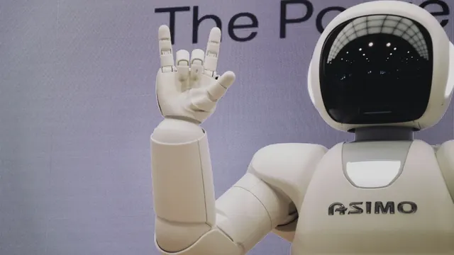 A humanoid robot and engineer working in a robotics lab