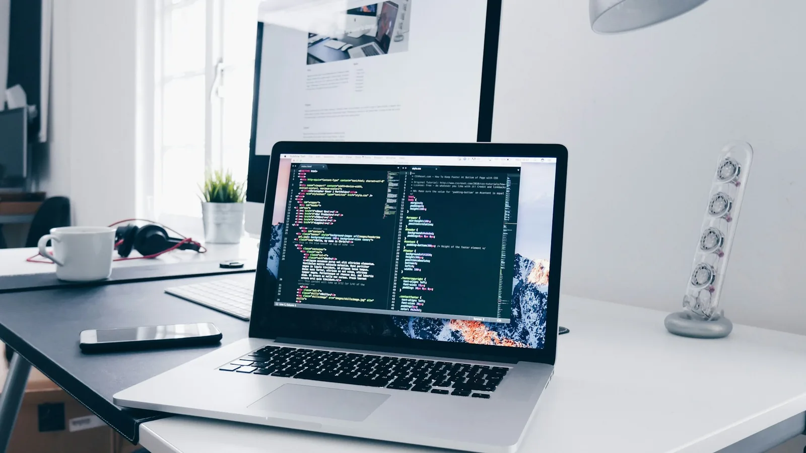 Developer analyzing analytics dashboards across multiple monitors